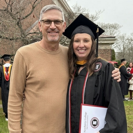 Ashley and her father Danny at her graduation, capturing an early chapter in a story that would later bring her to JM